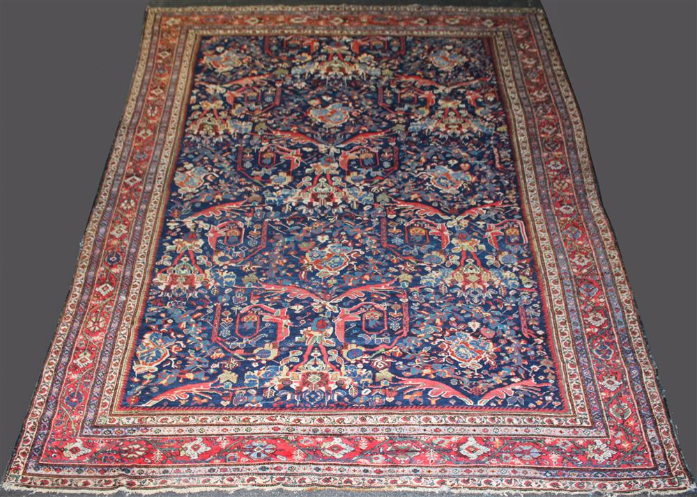 Appraisal: PERSIAN HERIZ ROOM SIZE RUG semi-antique having floral decorations with