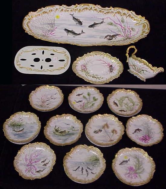 Appraisal: Limoges porcelain fish service handpainted aquatic designs shaped rims with