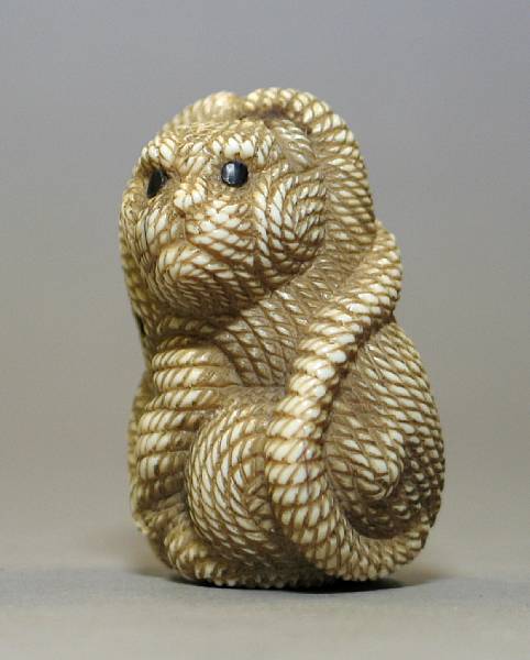 Appraisal: A tinted ivory netsuke of a tiger and a black