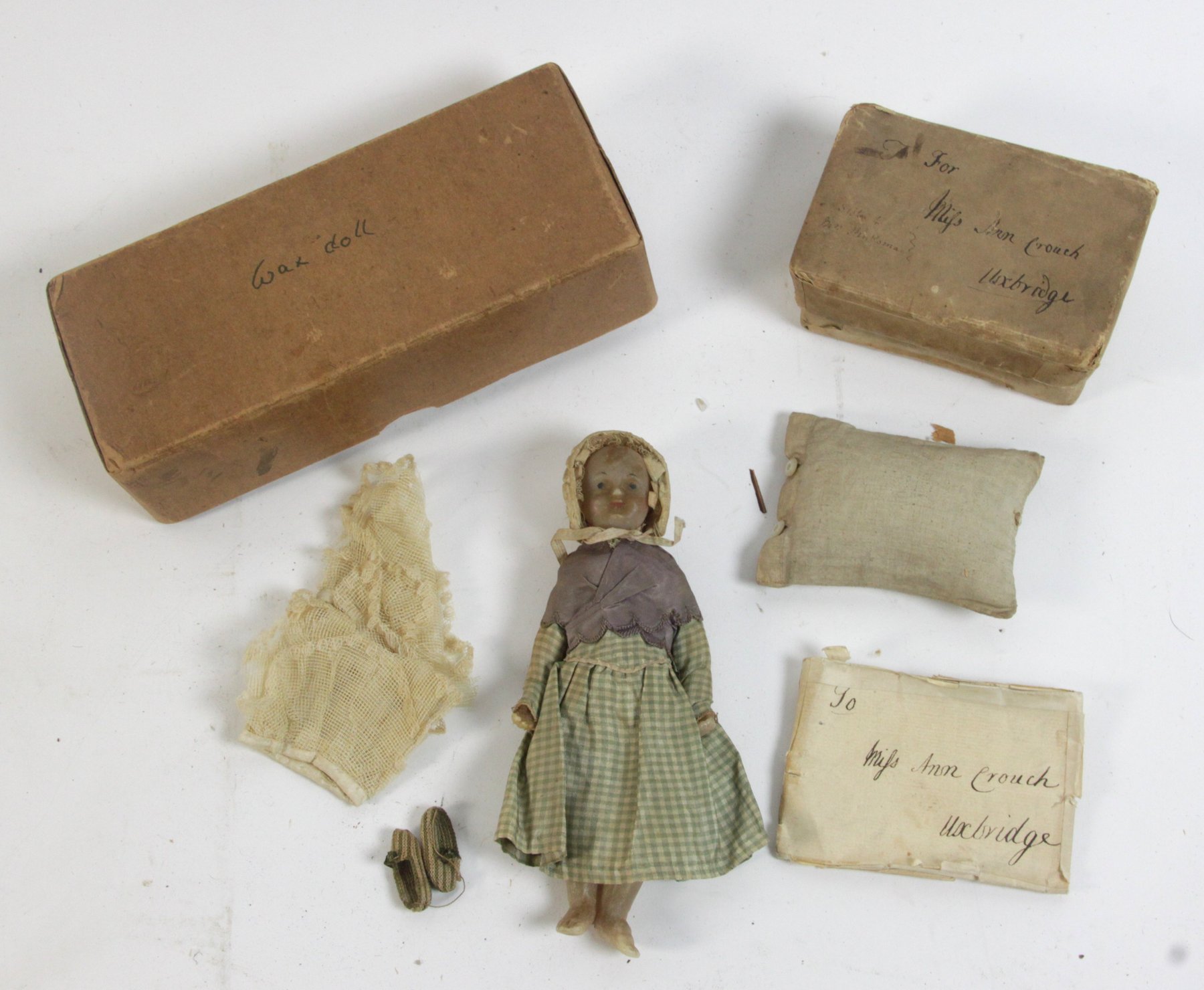 Appraisal: A wax doll with bonnet dress and shoes cm long