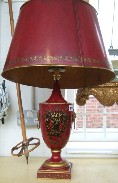 Appraisal: A rouge painted toleware lamp with lion ring handles and