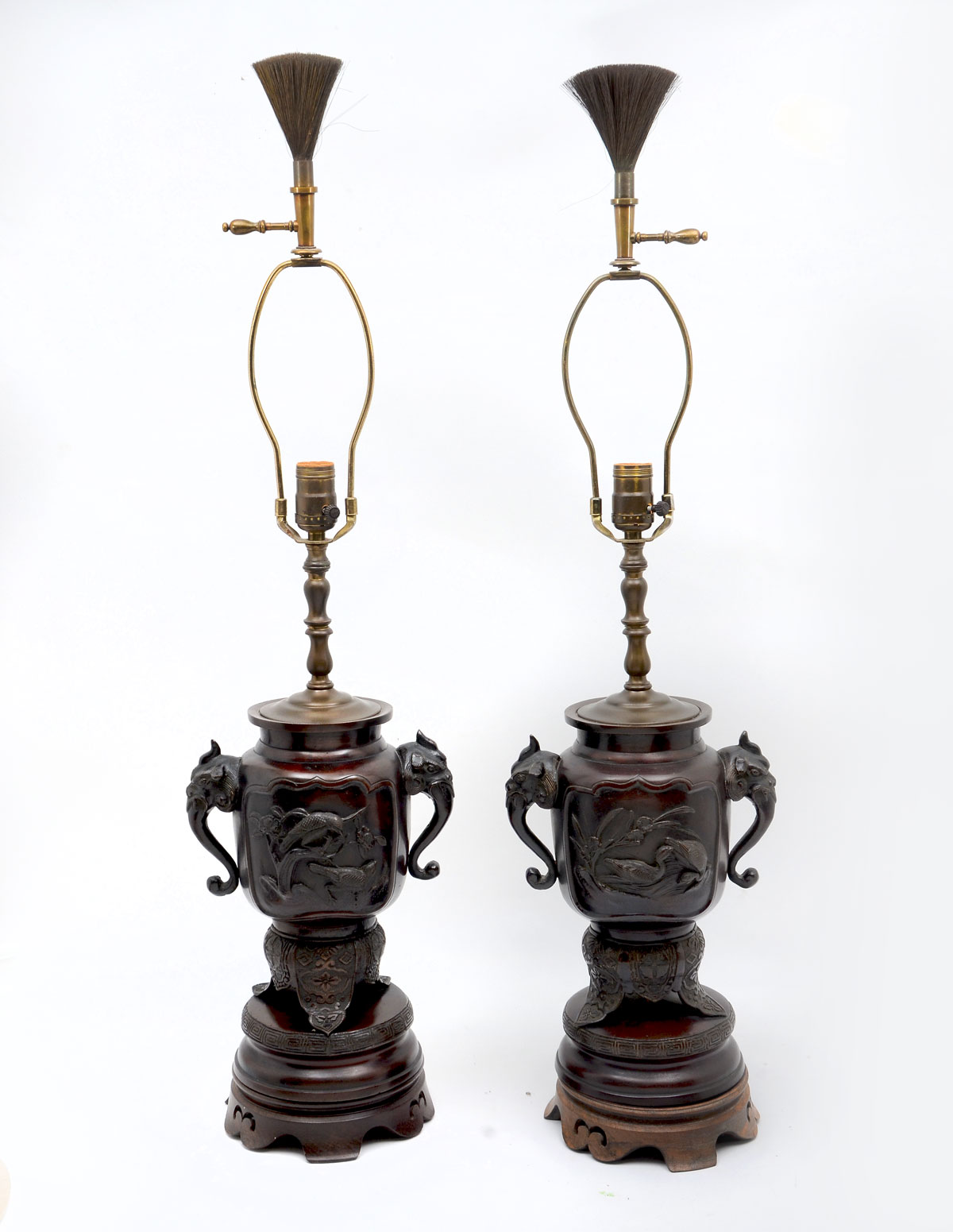 Appraisal: OPPOSING BRONZE JAPANESE FIGURAL LAMPS Bronze Japanese lamps surmounted by