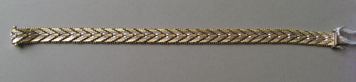 Appraisal: K yellow rose and white gold braided herringbone style bracelet