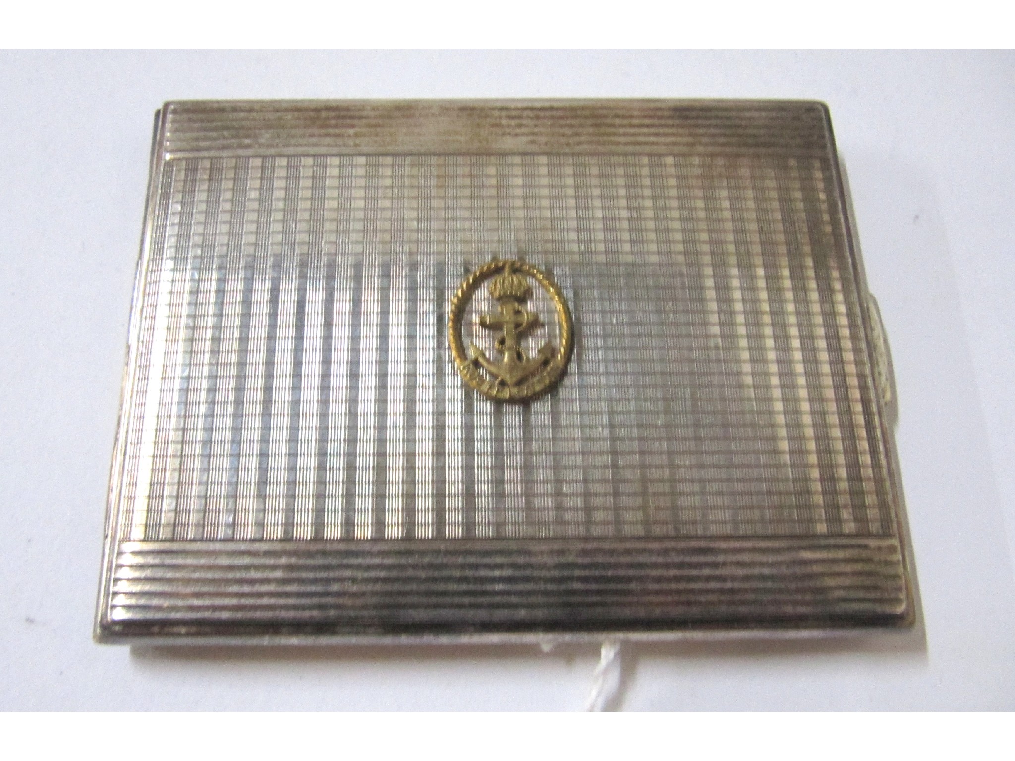 Appraisal: A white metal cigarette case with the Royal Navy Crest