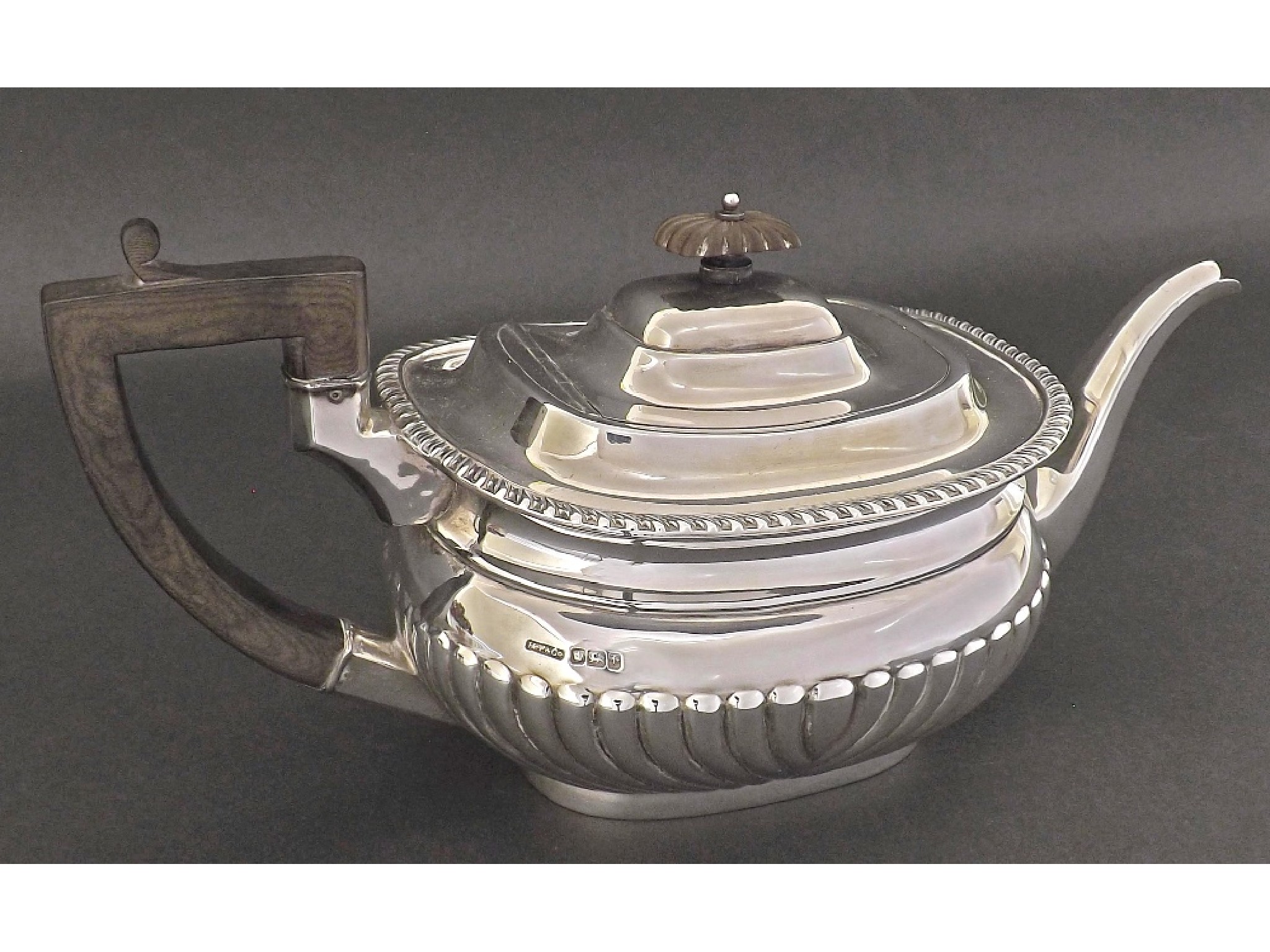 Appraisal: Early th century silver half fluted boat shaped teapot maker