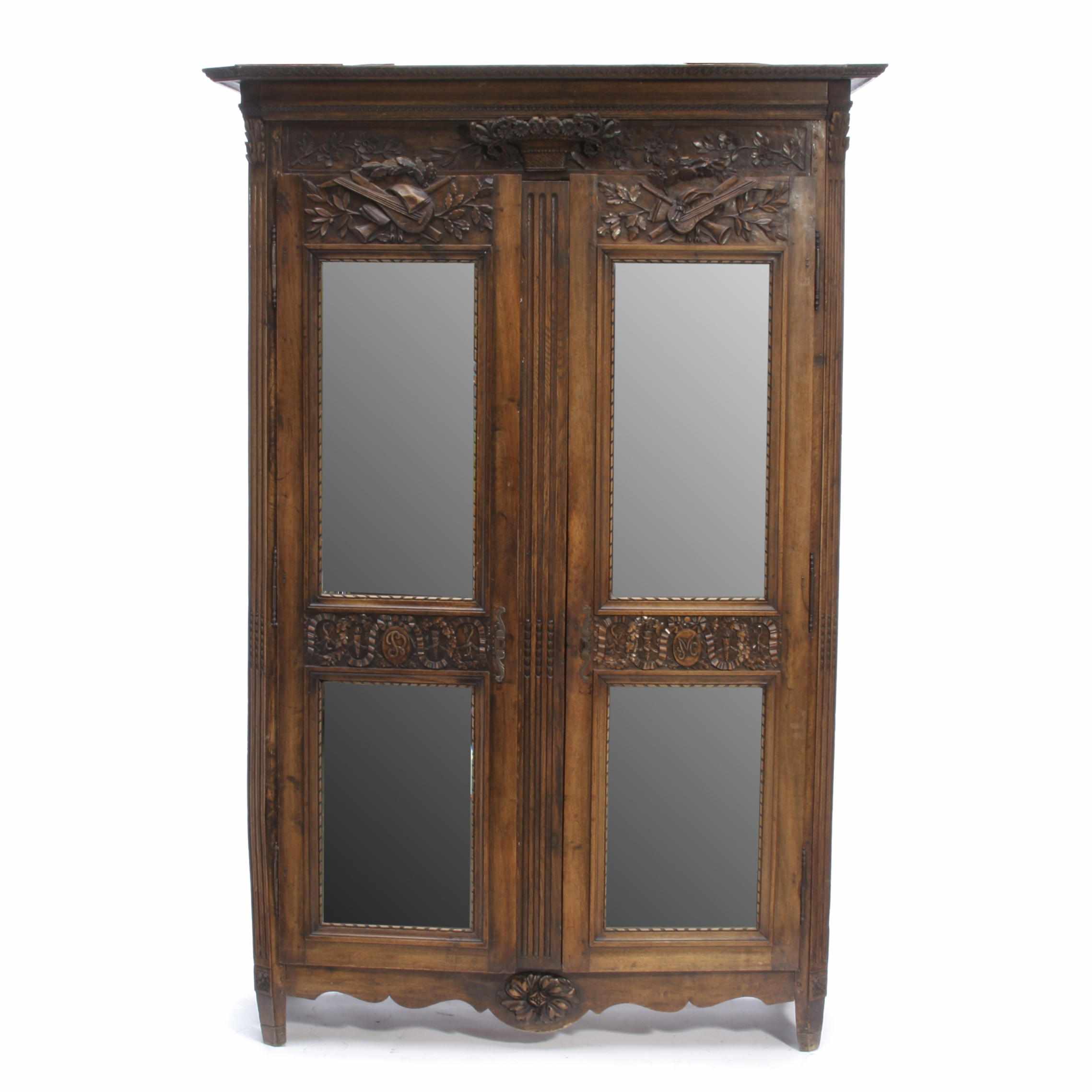 Appraisal: A Louis XVI Provincial oak armoire With later mirrored panels