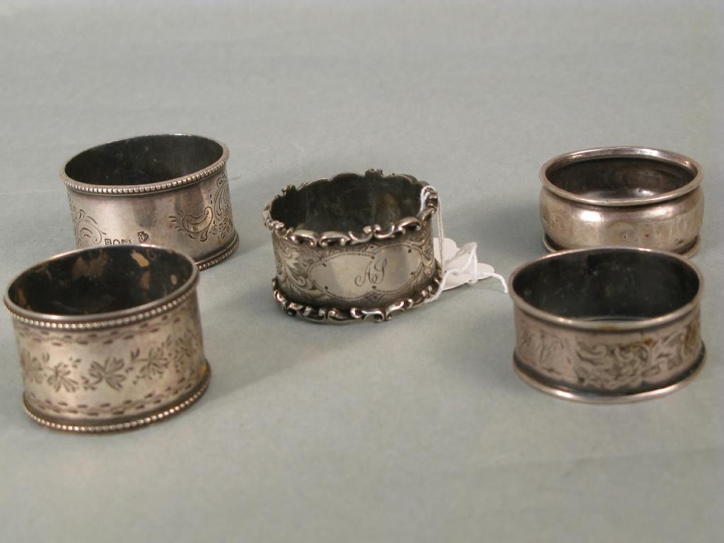 Appraisal: Five various silver serviette rings ozs total