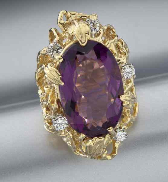 Appraisal: K gold amethyst and diamond ringfeaturing a natural oval modified