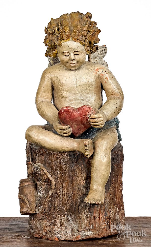 Appraisal: Painted redware figure of cupid Exclusive on Bidsquare Painted redware