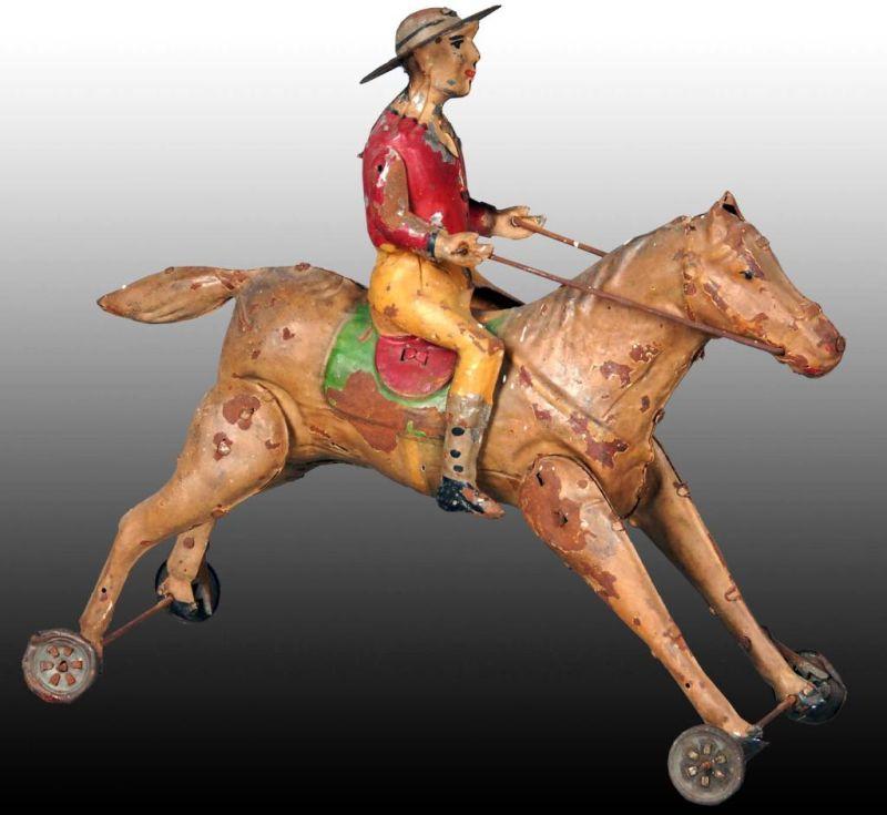 Appraisal: German Tin Wind-Up Cowboy on Horse Toy Description Hand-painted Missing