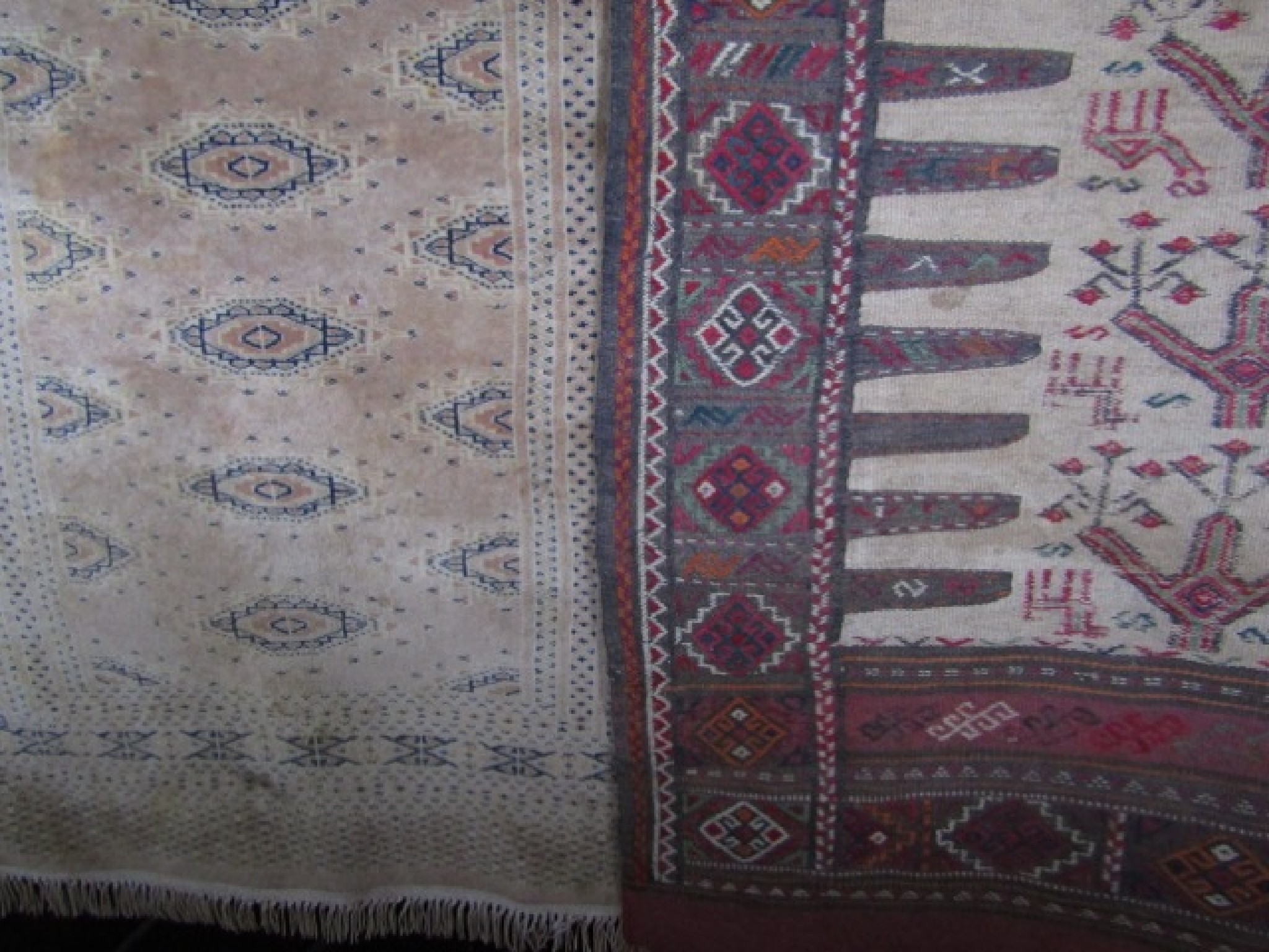 Appraisal: An eastern wool work rug with central cream field decorated