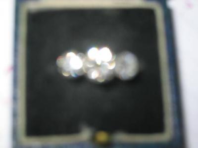 Appraisal: A THREE STONE DIAMOND RING comprising central stone flanked by