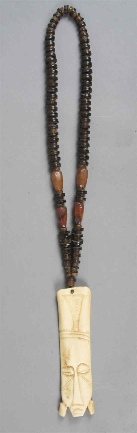 Appraisal: An African Carved Ivory or Bone Pendant hung from a