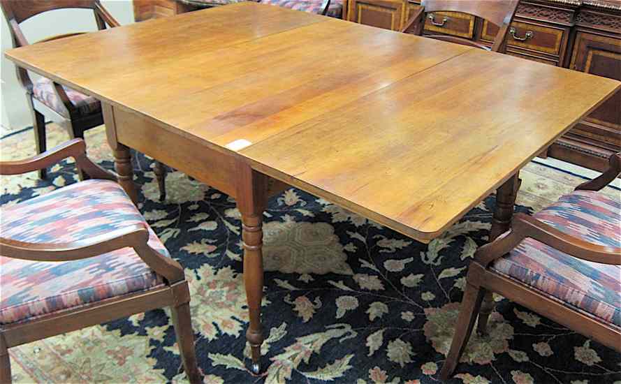 Appraisal: ANTIQUE DROP-LEAF CHERRY DINING TABLE American th century having a