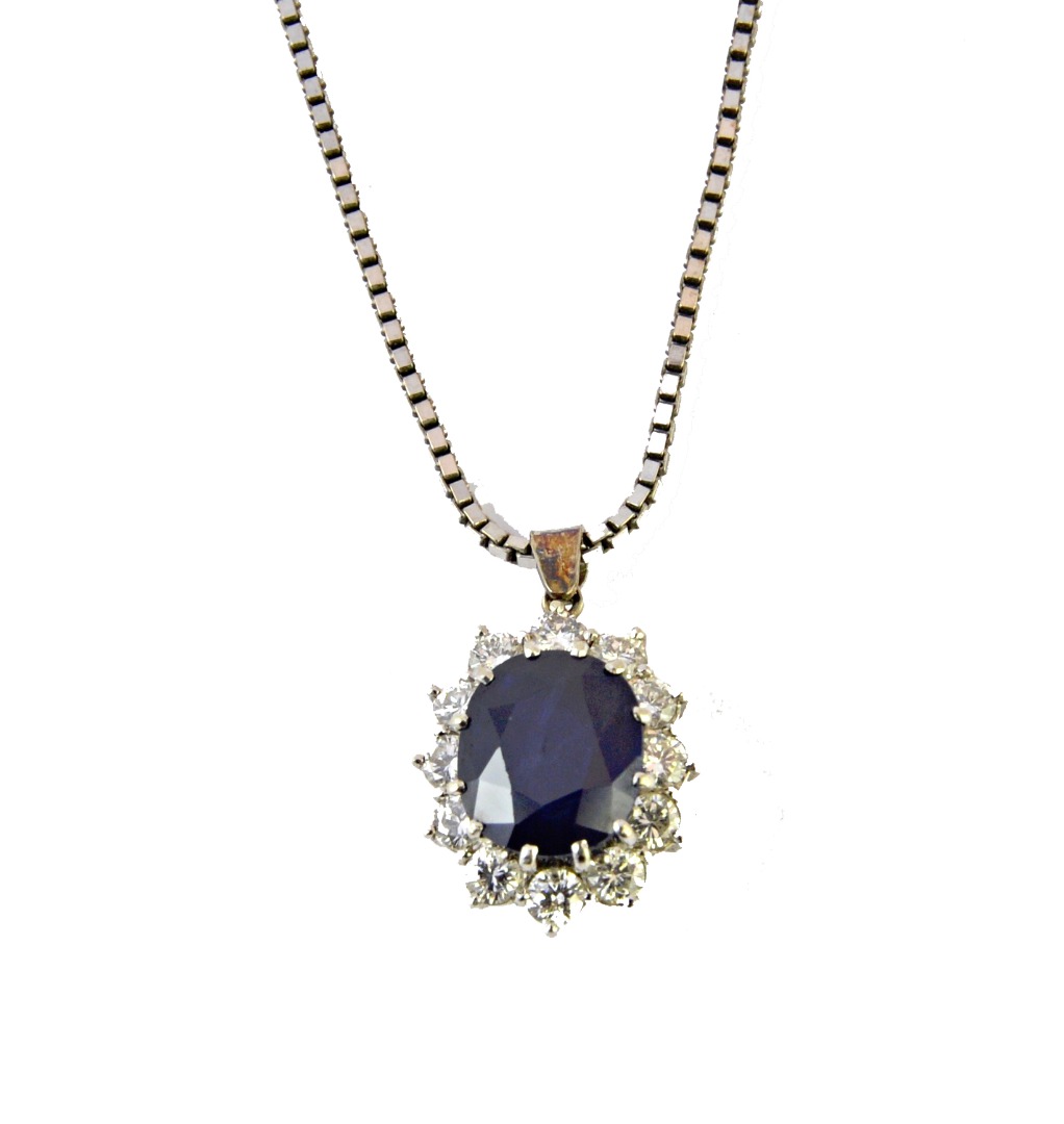 Appraisal: A sapphire and diamond set oval cluster pendant claw set