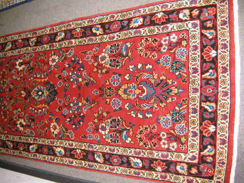 Appraisal: SAROUK RUNNER The rich red field shows an allover pattern