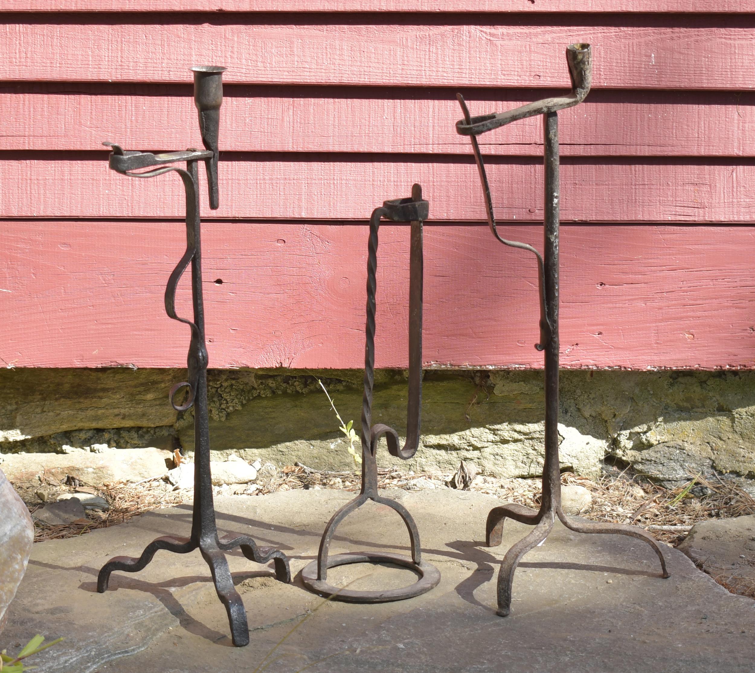 Appraisal: THREE EARLY IRON LIGHTING DEVICES th C hand wrought iron