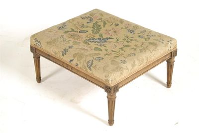 Appraisal: A walnut and beechwood footstool the floral tapestry seat to