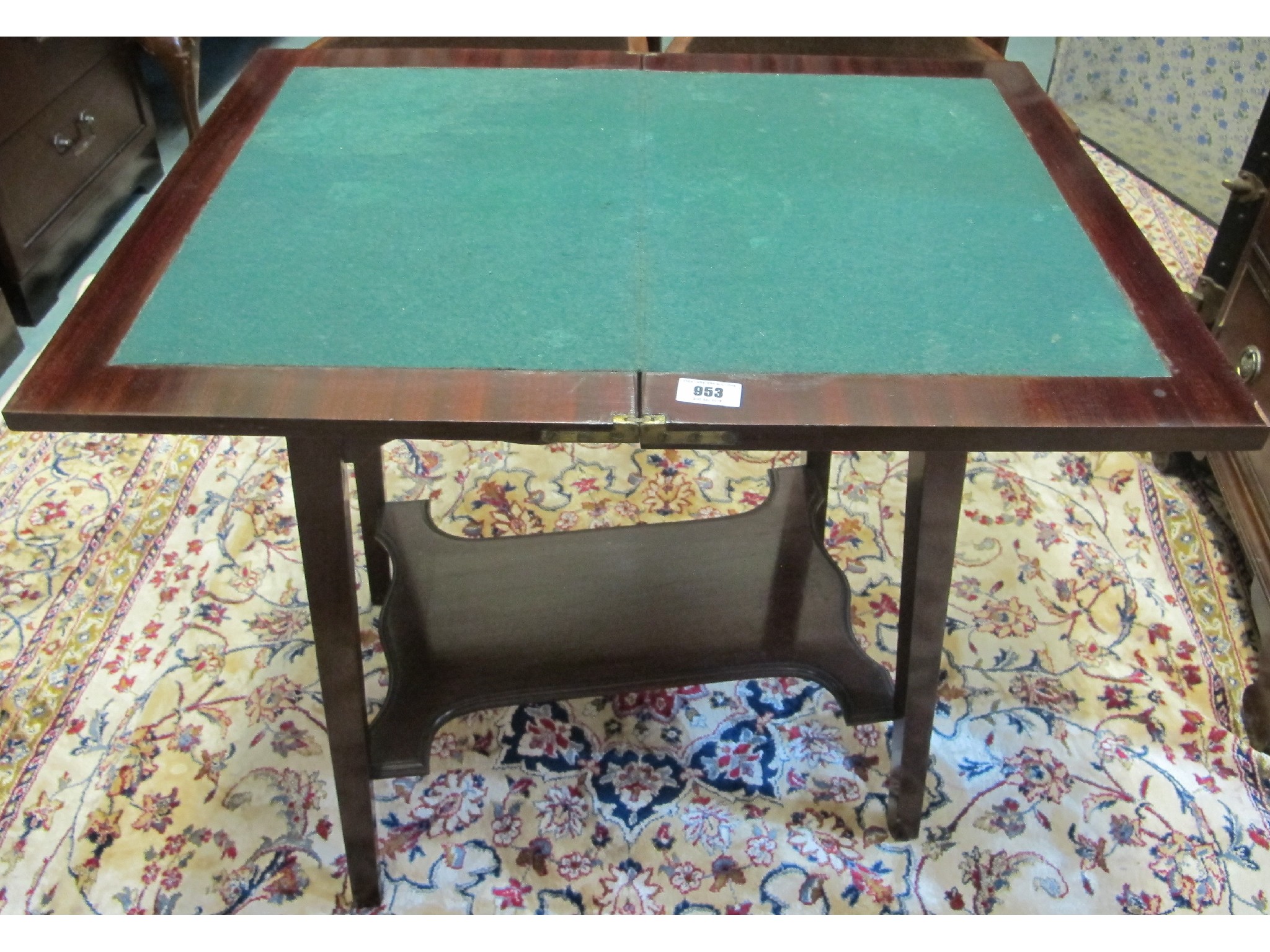 Appraisal: A small mahogany fold over card table