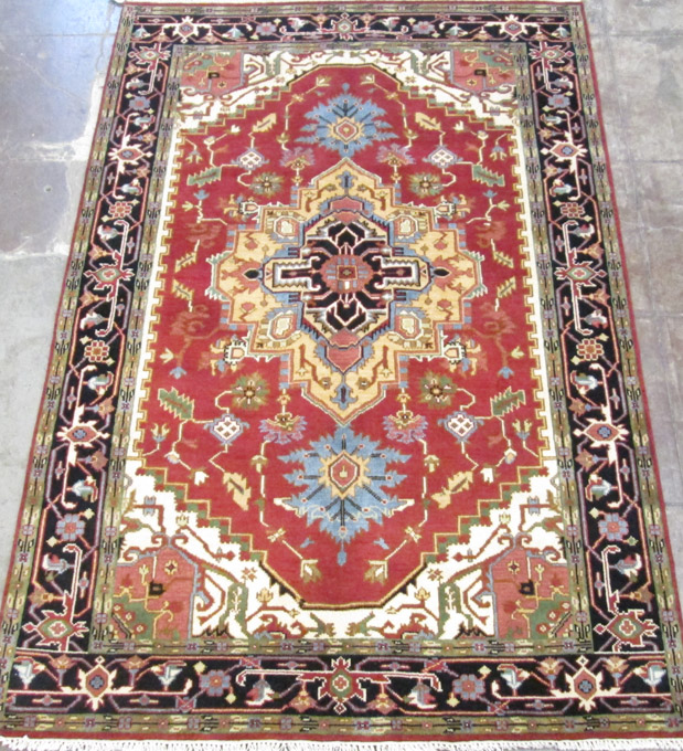 Appraisal: HAND KNOTTED ORIENTAL CARPET Persian Serapi design on red ground