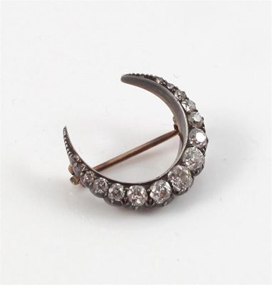 Appraisal: A Victorian small closed crescent brooch Set with graduated cushion