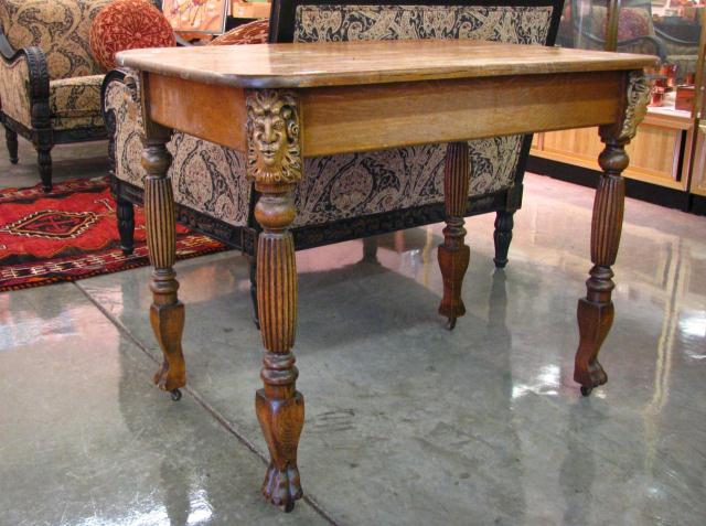 Appraisal: Golden Oak Library Table with Figural Carvings reeded legs with