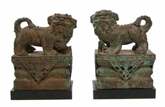 Appraisal: A Pair of Bronze Fu Dogs the animals depicted in