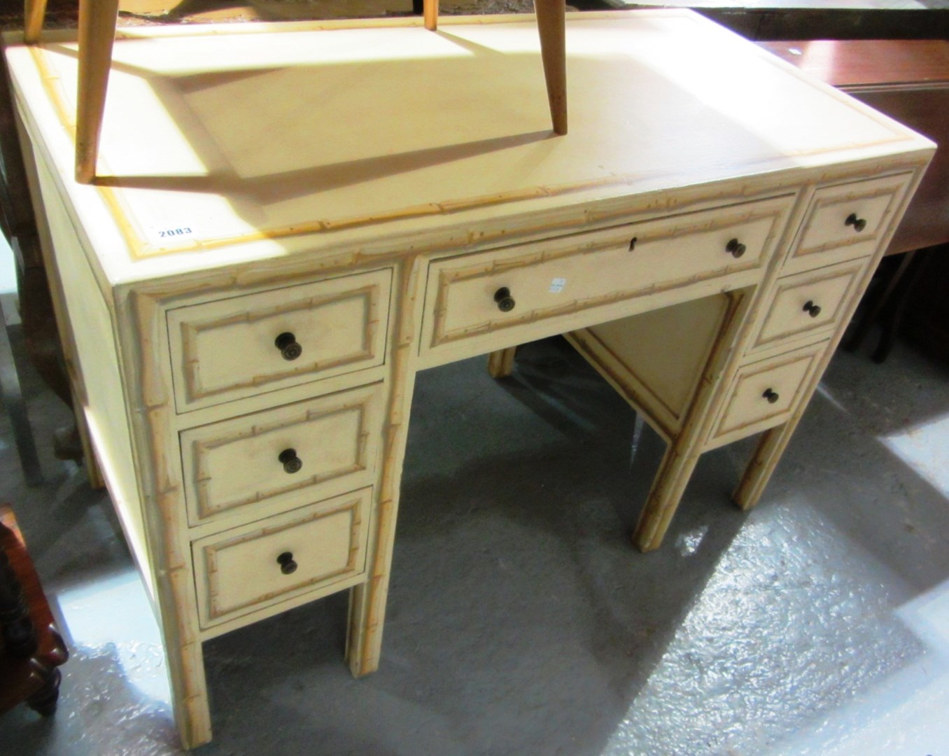 Appraisal: A th century yellow painted faux bamboo kneehole dressing table