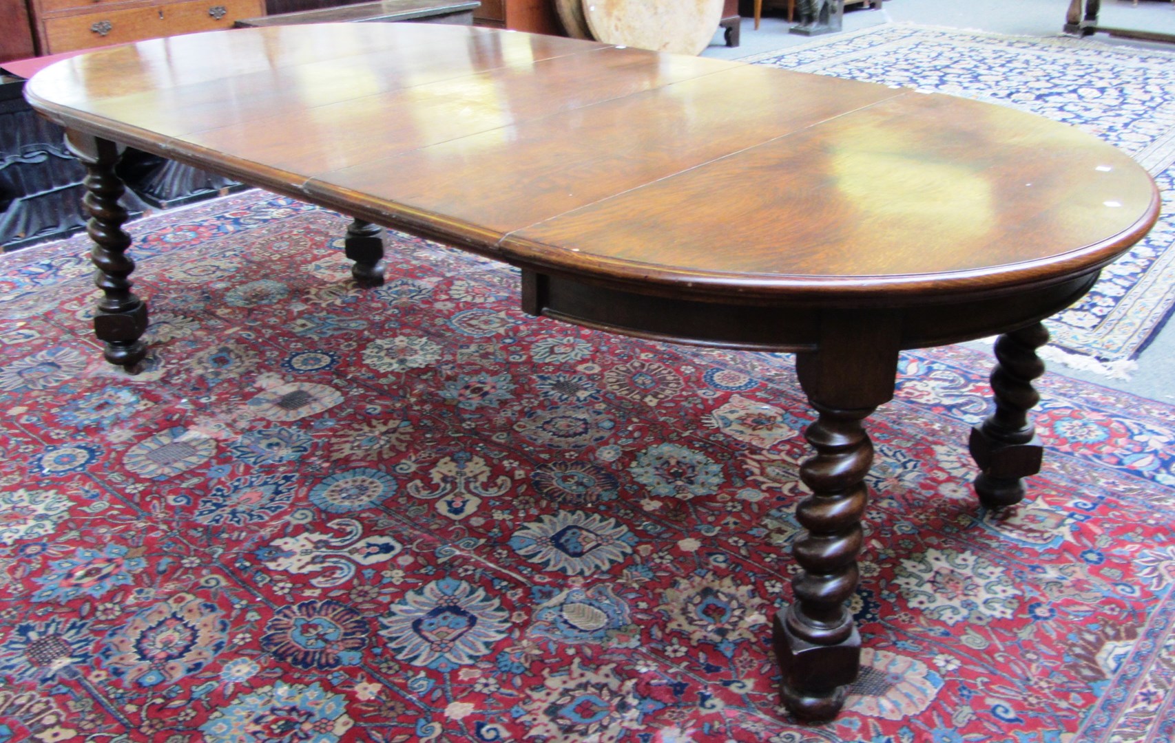 Appraisal: A th century oak circular extending dining table on barley-twist