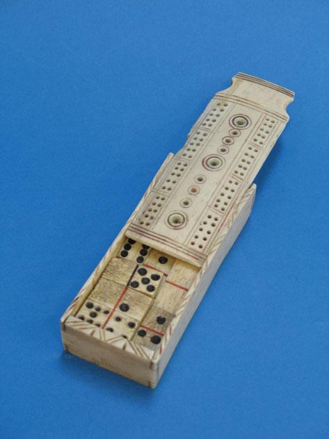 Appraisal: A MINIATURE PRISONER OF WAR DOMINOES SET in a carved