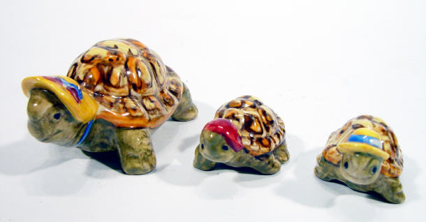 Appraisal: Unmarked Wade style three piece tortoise family each wearing bonnets