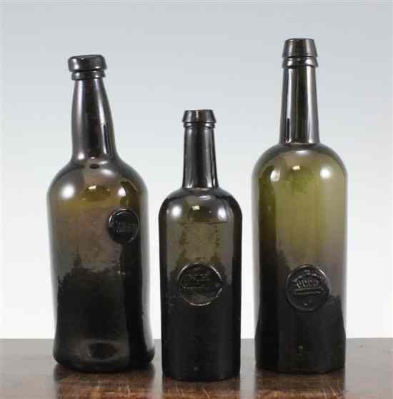 Appraisal: An English black glass sealed wine bottle c cylindrical body