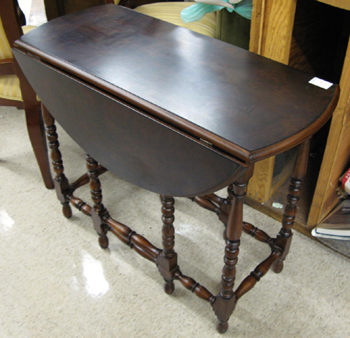 Appraisal: A BURL WALNUT DROP-LEAF OCCASIONAL TABLE the oblong top having