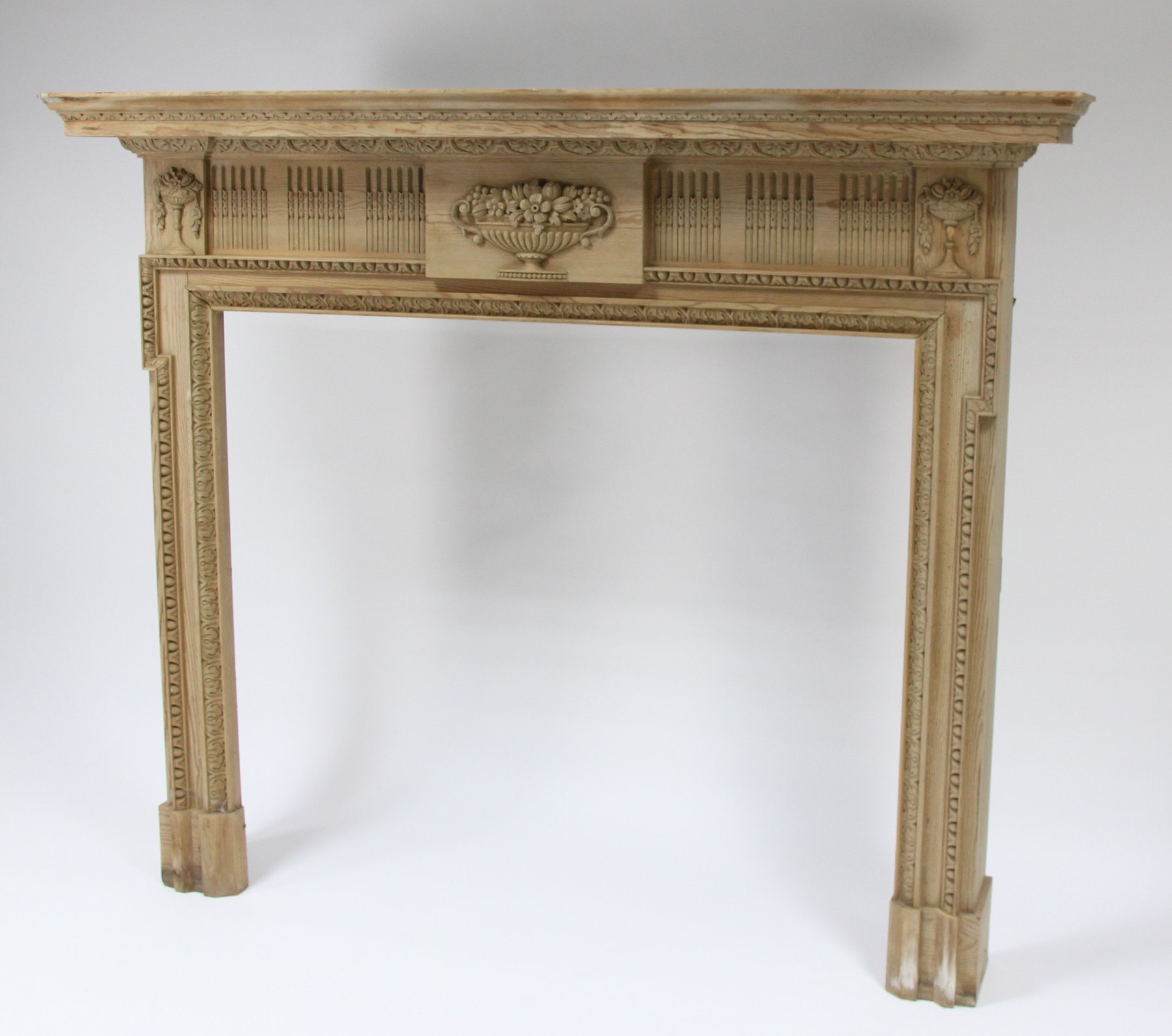 Appraisal: An Adam style carved pine fire surround the frieze carved