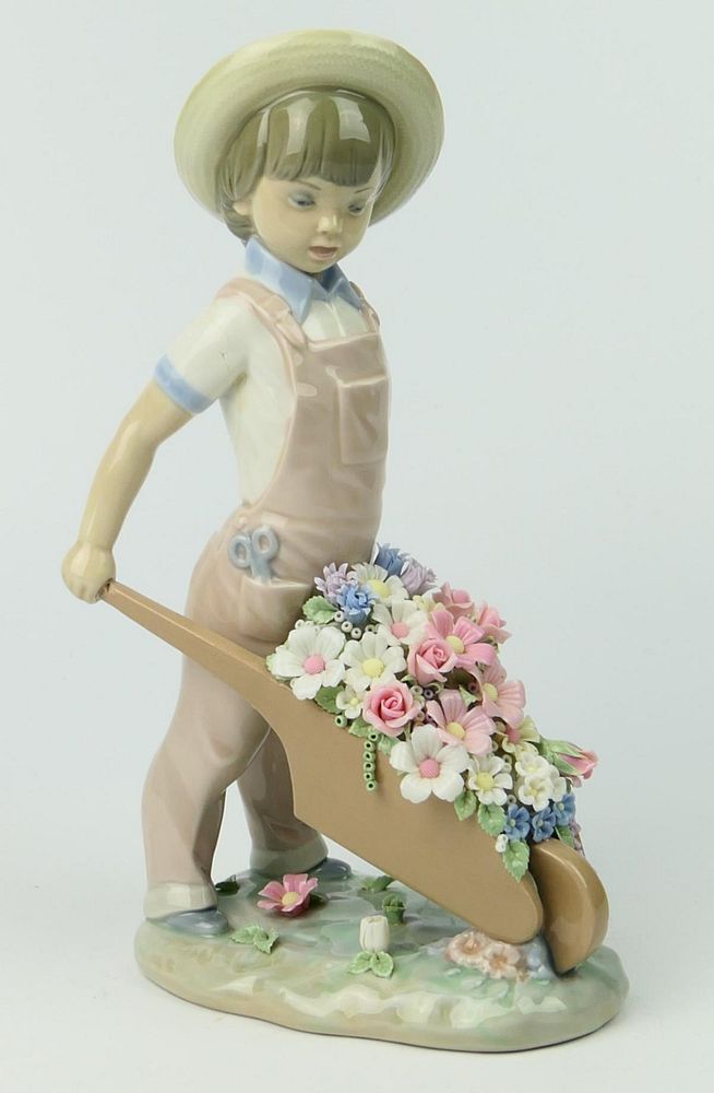 Appraisal: LLADRO FIGURINE BOY WHEELING FLOWERS GLOSSY Condition All lots are