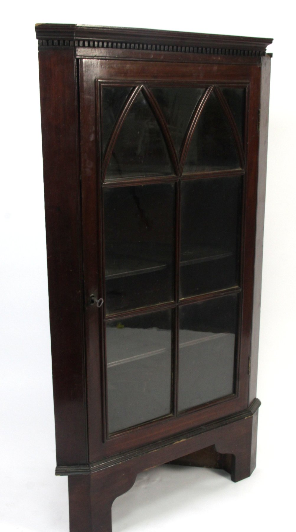 Appraisal: A George III mahogany hanging corner cupboard the dentil cornice