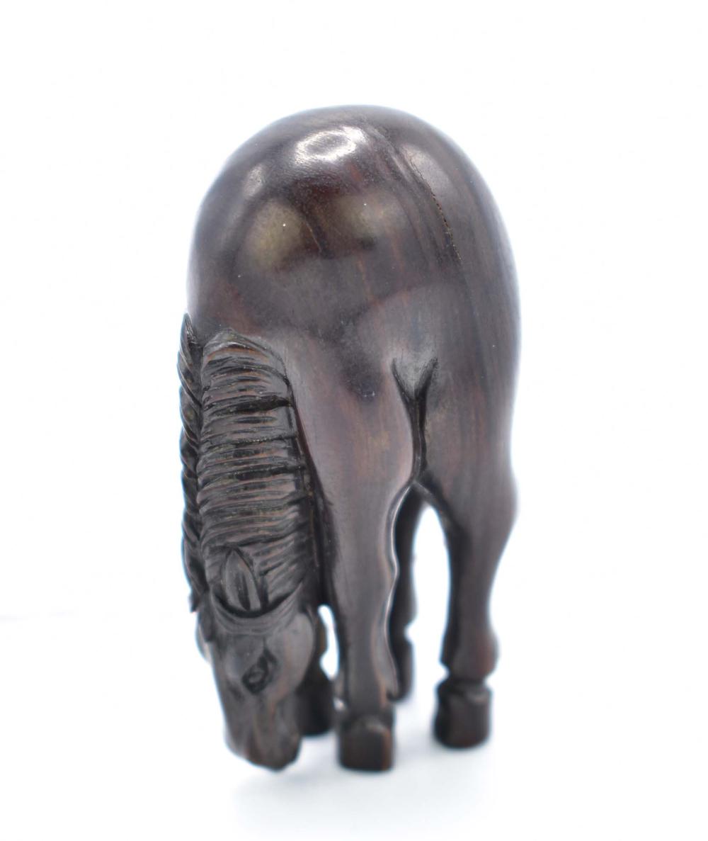 Appraisal: JAPANESE CARVED WOOD HORSE NETSUKEUnsigned In an exaggerated arched form