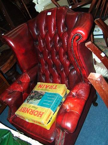 Appraisal: A red leather wing back arm chair on cabriole legs