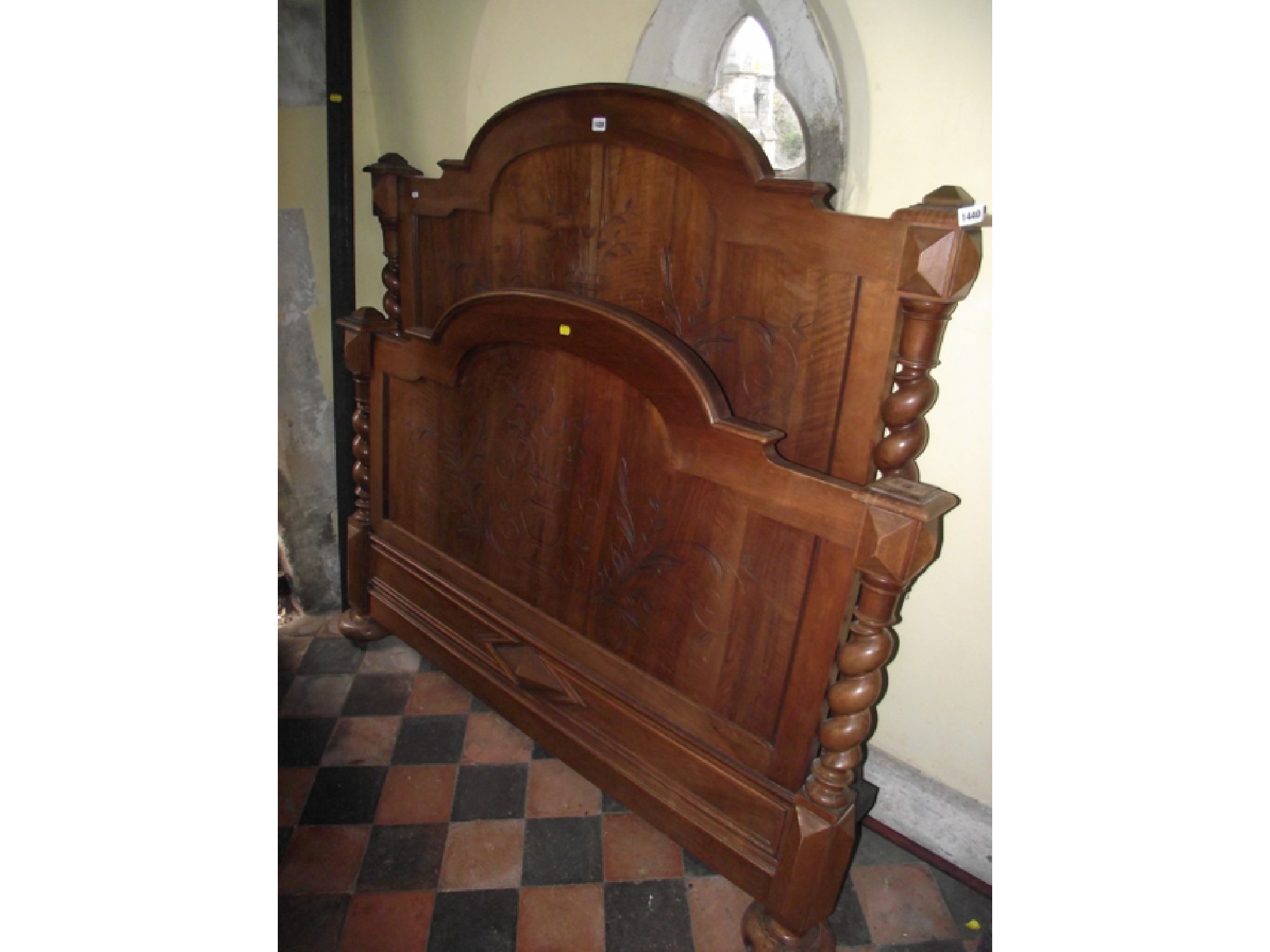 Appraisal: A th century continental walnut bedstead with carved foot and