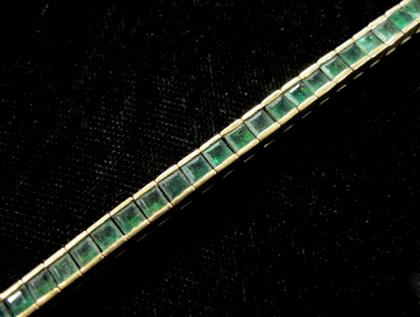 Appraisal: karat yellow gold and emerald line braceletFifty-eight square cut carat