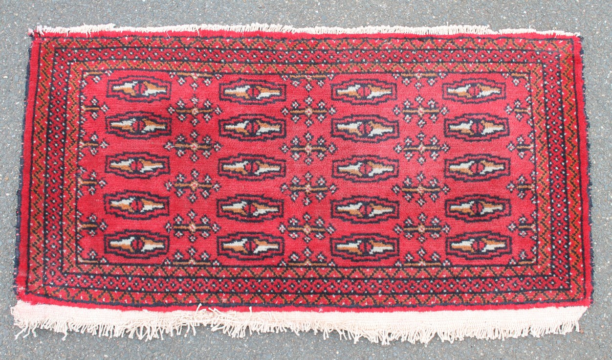 Appraisal: A Turkoman carpet runner in red repeated design cm x