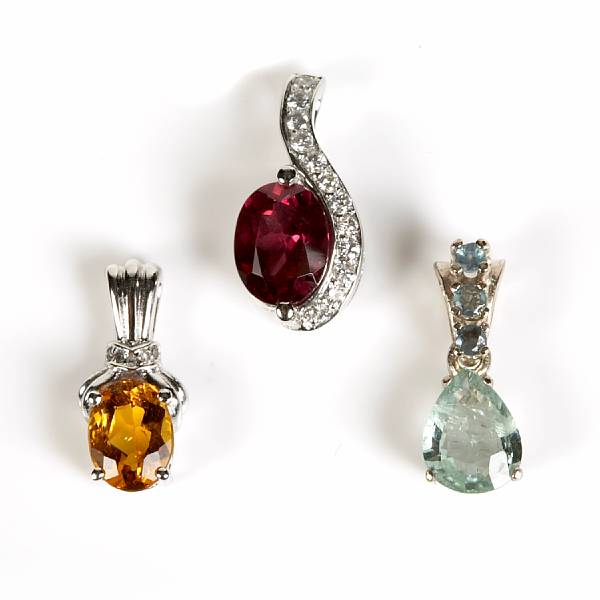 Appraisal: A collection of three gem-set and white gold pendants grs