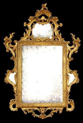 Appraisal: ITALIAN ROCOCO GILTWOOD MIRROR The molded and strapwork frame within