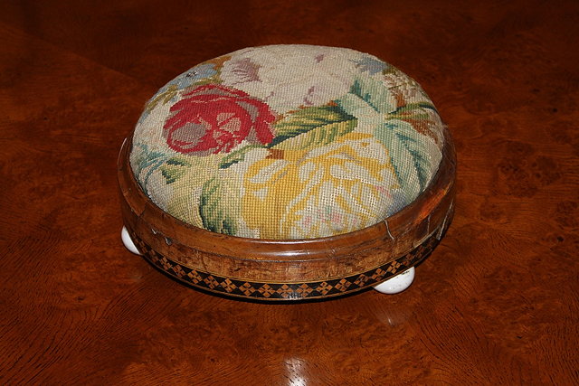 Appraisal: A VICTORIAN WALNUT AND INLAID CIRCULAR FOOTSTOOL with original woolwork