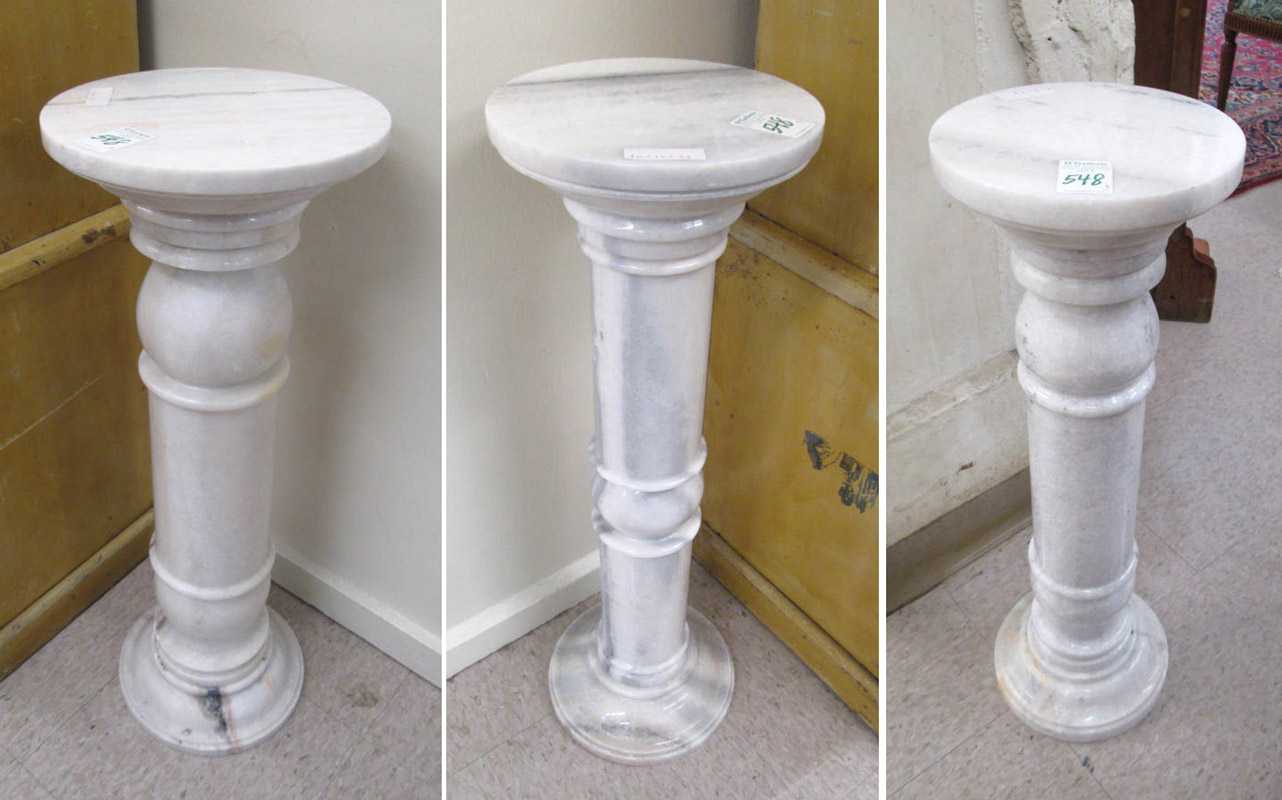 Appraisal: THREE CARARA MARBLE PEDESTALS all with round tops over baluster-turned