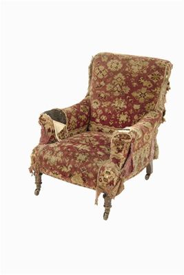 Appraisal: A late Victorian easy armchair on turned mahogany legs on