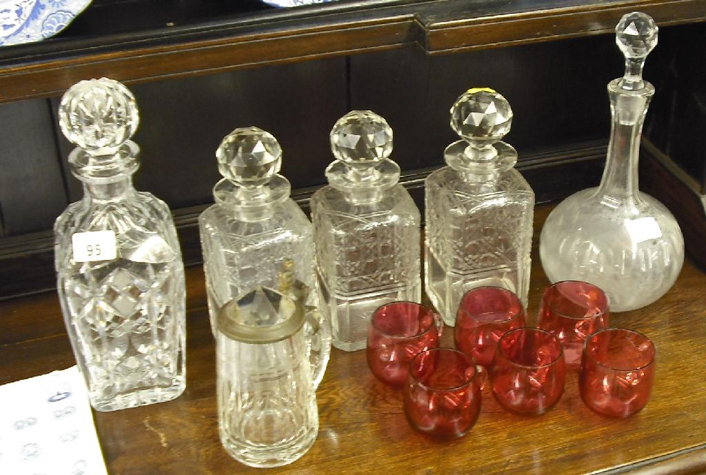 Appraisal: Set of three cut glass whiskey decanters and stoppers two