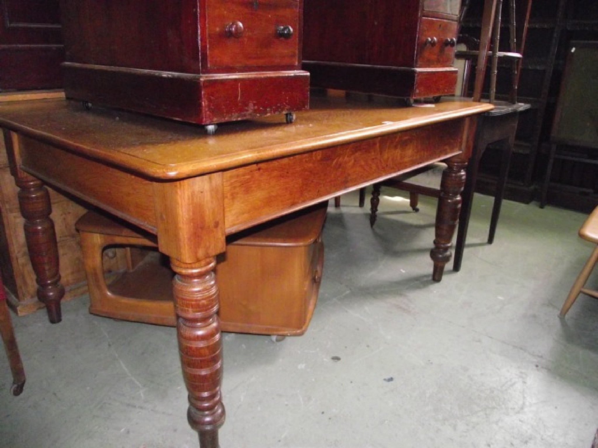 Appraisal: An Edwardian medium oak dining table the rectangular planked top