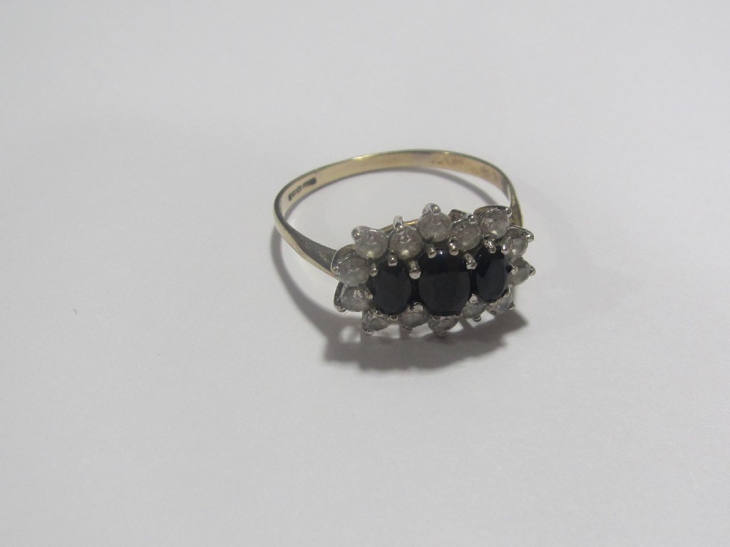 Appraisal: Nine carat gold sapphire and cz cluster ring