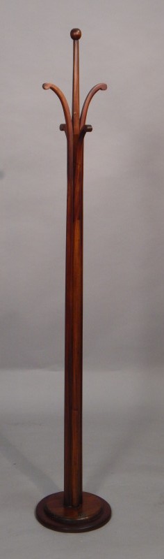 Appraisal: A modern mahogany coat stand on a circular base bearing